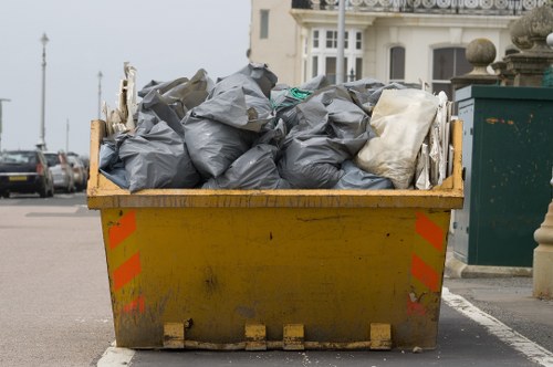 Team members from Skip Hire Edmonton preparing a skip