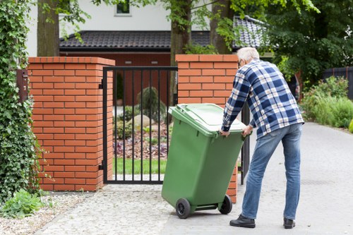 Skip Hire Edmonton truck at a residential site with operative wearing PPE